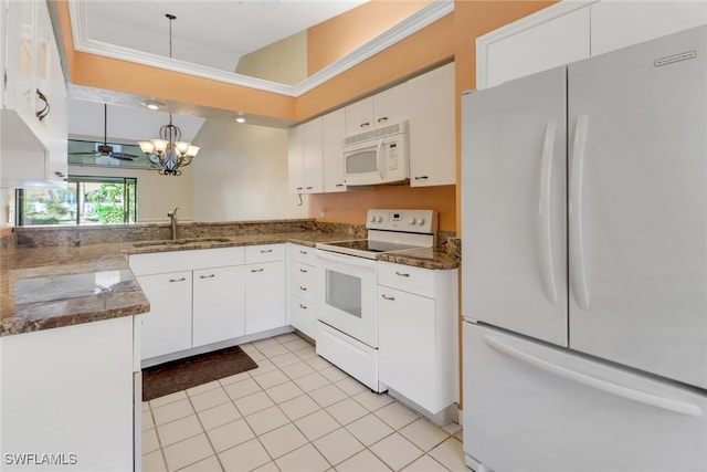 kitchen with sink, white cabinets, pendant lighting, and white appliances