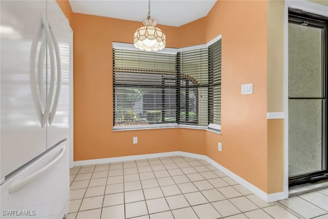 unfurnished dining area with light tile patterned floors