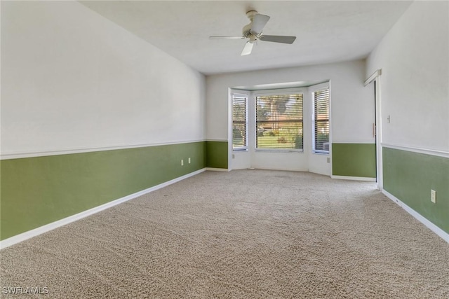 carpeted empty room with ceiling fan