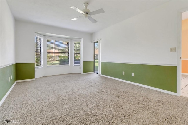 unfurnished room featuring ceiling fan and carpet flooring