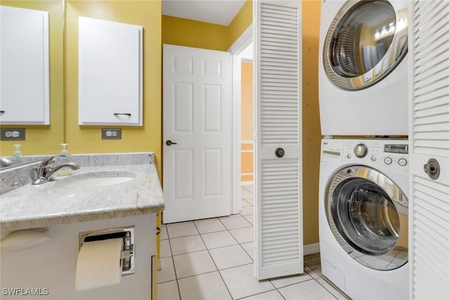 laundry room with sink, stacked washer and clothes dryer, and light tile patterned flooring