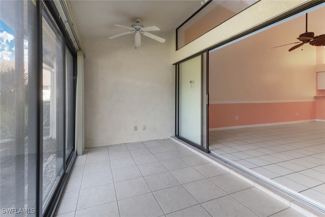 unfurnished sunroom featuring ceiling fan