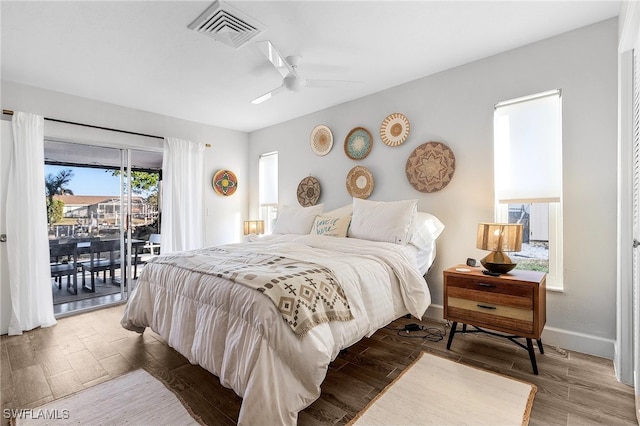 bedroom with hardwood / wood-style flooring, ceiling fan, and access to exterior