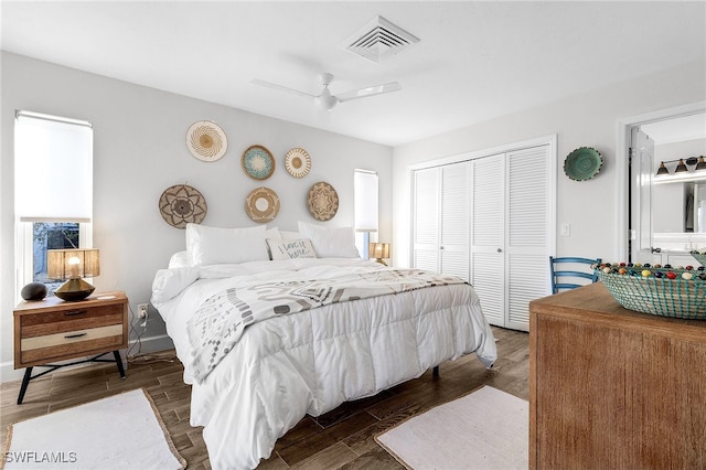 bedroom with a closet, dark hardwood / wood-style floors, and ceiling fan