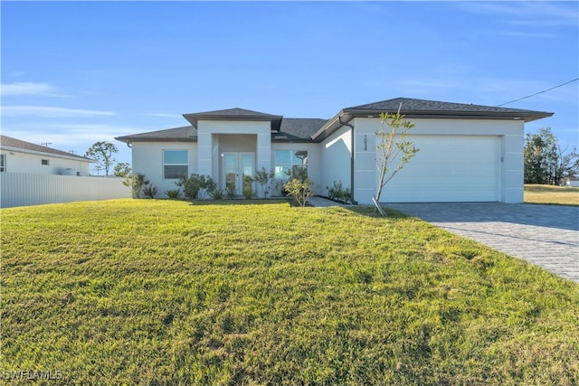 view of front of home with a front yard and a garage