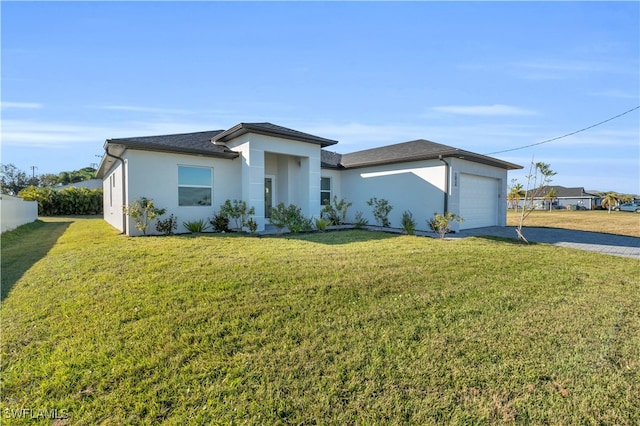 view of front of property featuring a front yard and a garage