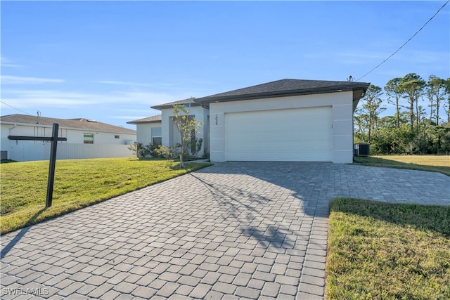 ranch-style home featuring central AC unit, a front yard, and a garage