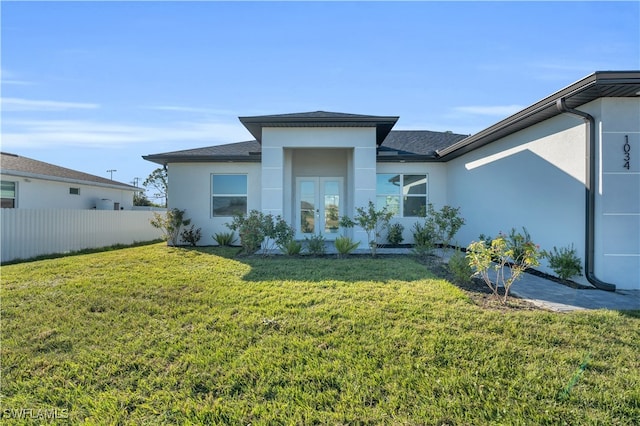 rear view of property featuring a yard and french doors