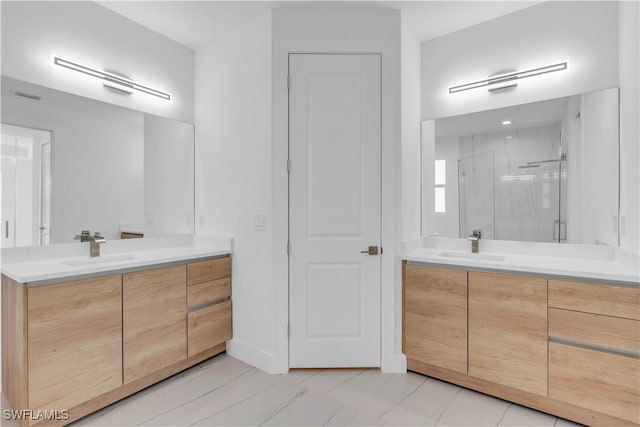 bathroom featuring vanity and a shower with shower door