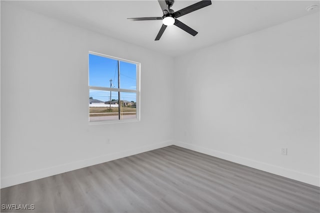 spare room with ceiling fan and hardwood / wood-style flooring