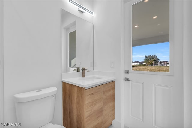 bathroom with vanity and toilet