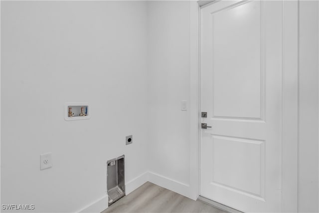 laundry area with hookup for a washing machine, light hardwood / wood-style floors, and electric dryer hookup