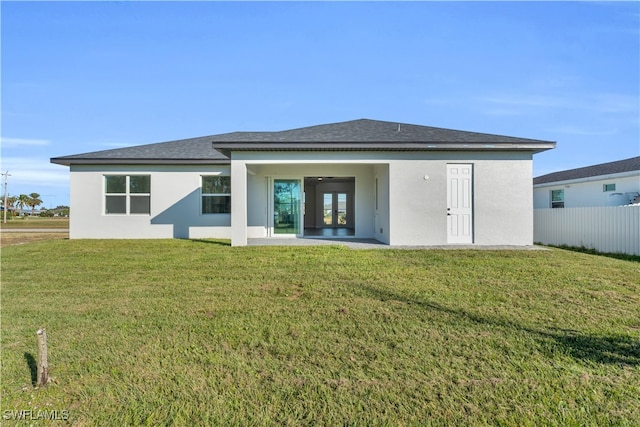 back of house with a yard and french doors