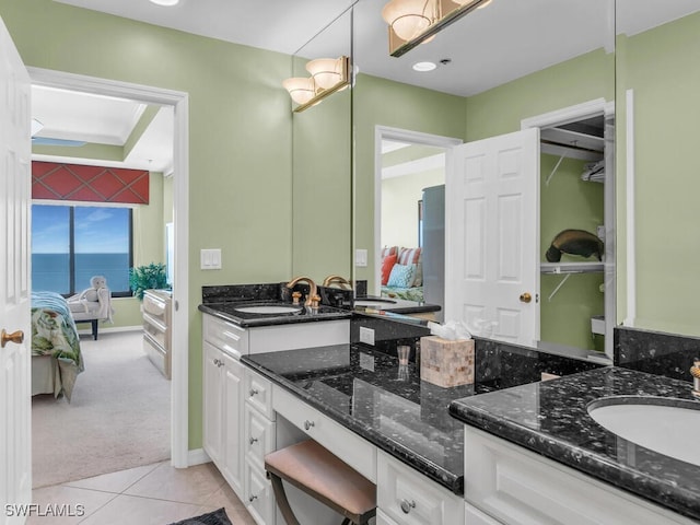 bathroom featuring tile patterned floors, a water view, and vanity