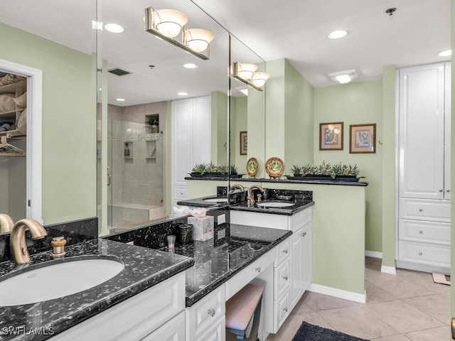 bathroom with tile patterned flooring, vanity, and an enclosed shower