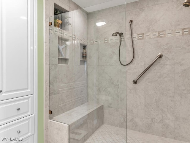 bathroom with a tile shower