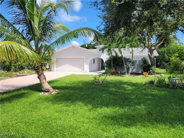 view of front of property with a front lawn and a garage