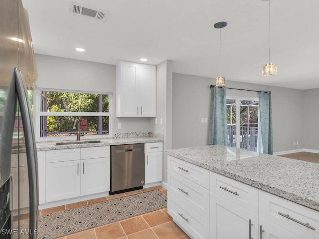 kitchen with white cabinets, plenty of natural light, sink, and appliances with stainless steel finishes