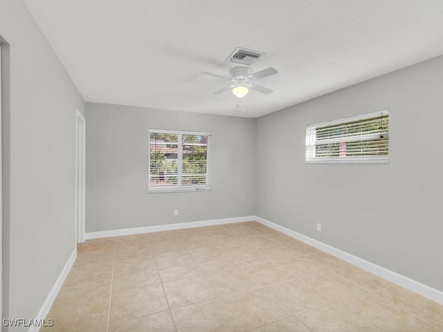 unfurnished room with ceiling fan and light tile patterned floors