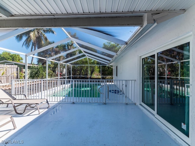 view of pool featuring glass enclosure and a patio area