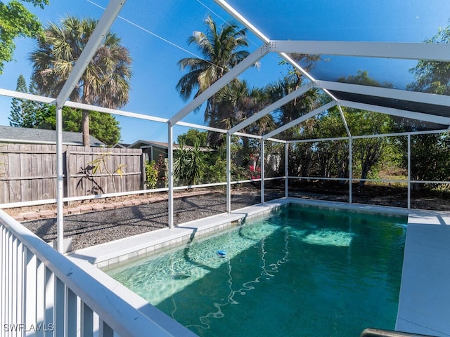 view of swimming pool with glass enclosure