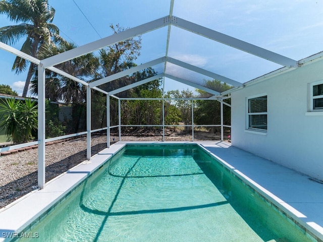 view of pool featuring glass enclosure