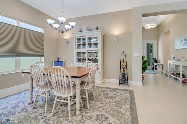 tiled dining space with an inviting chandelier