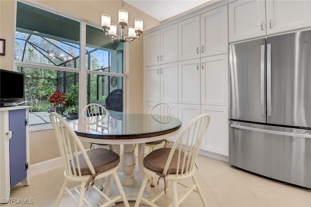 dining area with light tile patterned floors and an inviting chandelier