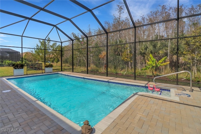 view of pool with a patio area and a lanai