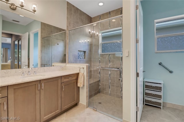 bathroom featuring vanity, tile patterned floors, and a shower with door