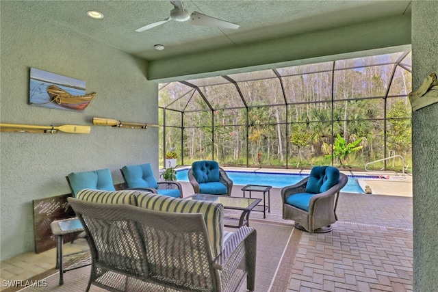 view of patio / terrace with outdoor lounge area, ceiling fan, and a lanai