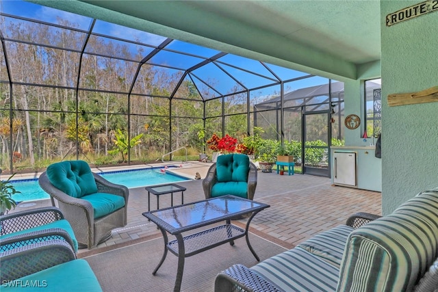 view of patio with glass enclosure and an outdoor hangout area