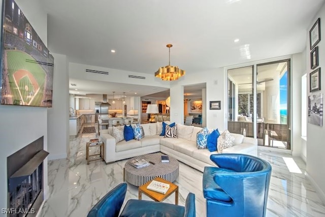 living room with a fireplace and an inviting chandelier