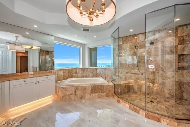 bathroom featuring a raised ceiling, vanity, separate shower and tub, and a notable chandelier