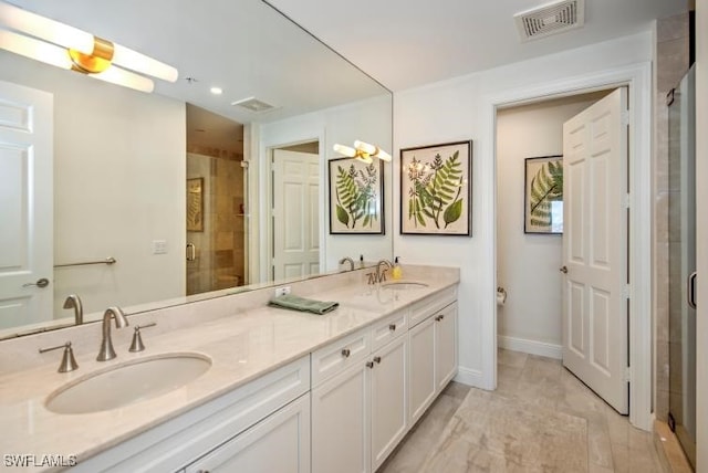 bathroom featuring vanity and an enclosed shower