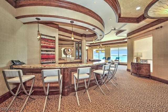 bar with a water view, crown molding, and carpet