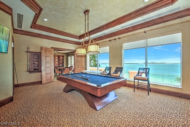 playroom featuring carpet flooring, a raised ceiling, billiards, crown molding, and a water view