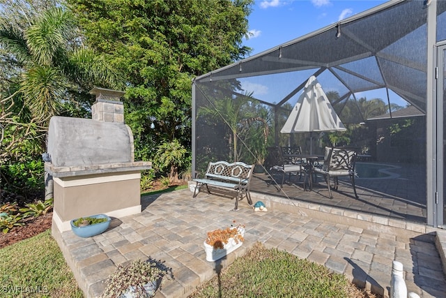 view of patio / terrace featuring glass enclosure