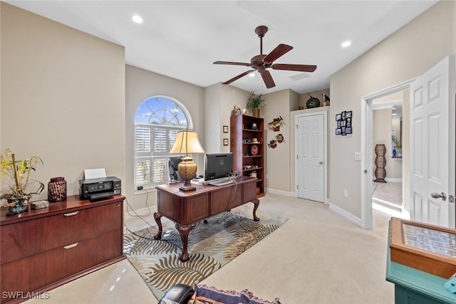 carpeted office featuring ceiling fan