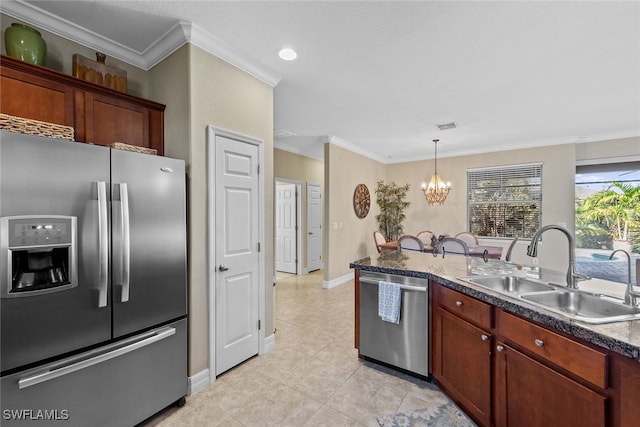 kitchen featuring appliances with stainless steel finishes, crown molding, sink, decorative light fixtures, and an inviting chandelier