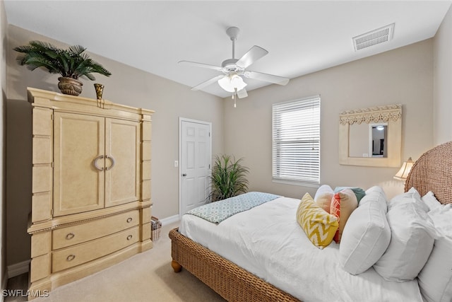 bedroom featuring ceiling fan and light colored carpet