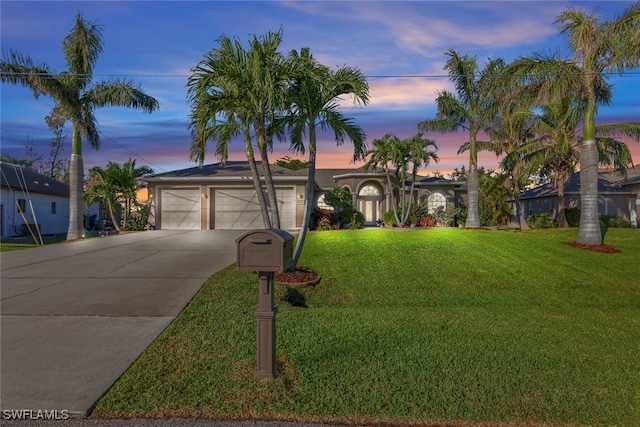 view of front of property with a lawn and a garage