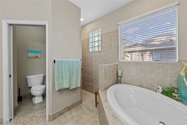 bathroom featuring tile patterned flooring, shower with separate bathtub, and toilet