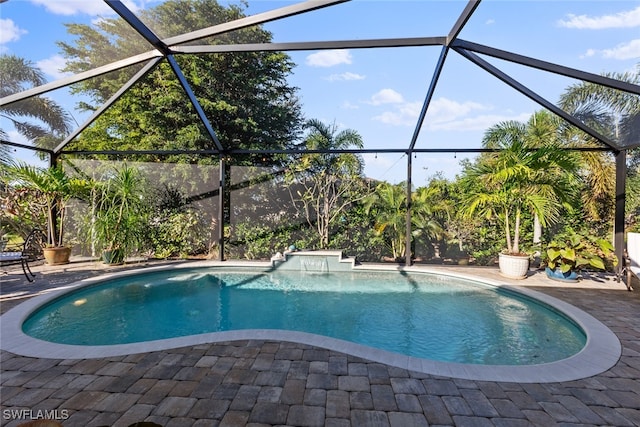 view of swimming pool featuring a patio and glass enclosure