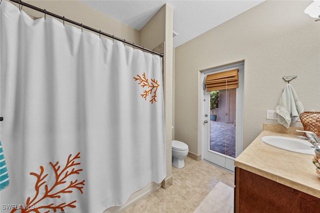 bathroom with tile patterned floors, vanity, and toilet