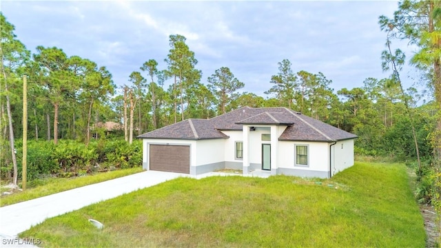 view of front of house featuring a front yard and a garage