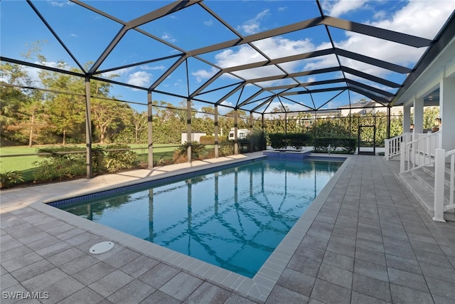 view of pool with a lanai and a patio