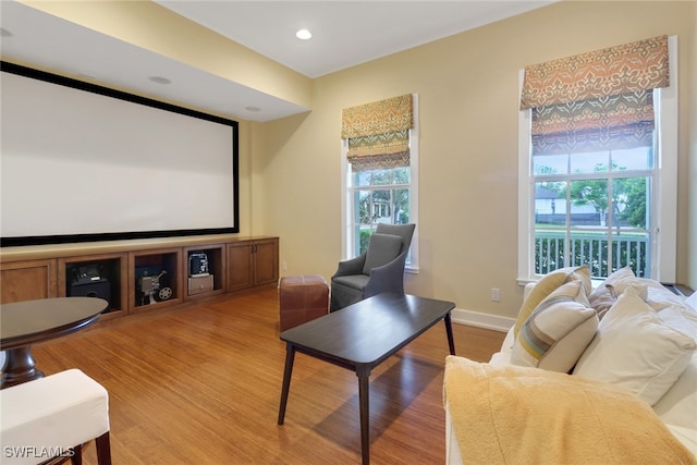 cinema room with light wood-type flooring