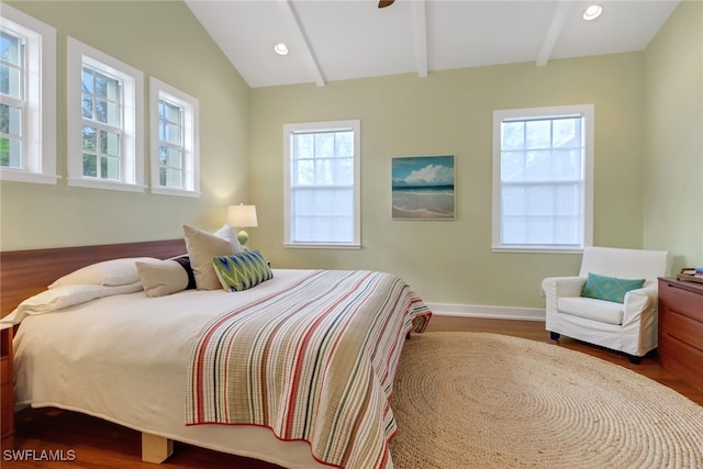 bedroom featuring hardwood / wood-style floors, lofted ceiling with beams, and multiple windows