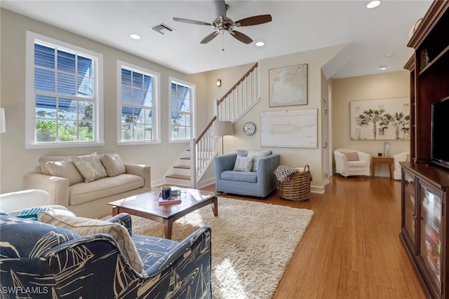 living room featuring wood-type flooring, a wealth of natural light, and ceiling fan